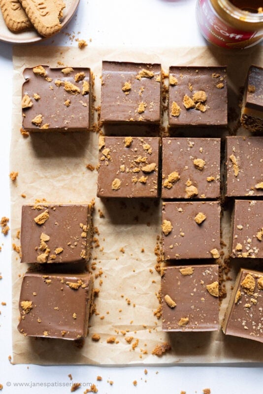 A large tray of cut Biscoff Millionaires with slices missing