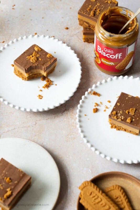 A jar of Biscoff spread and a bite missing from a Biscoff Millionaires