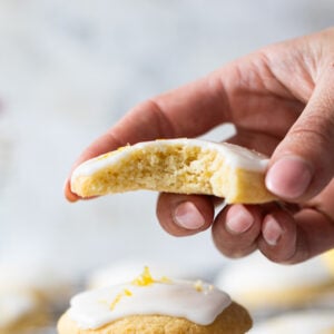 A bite taken from a glazed lemon cookie