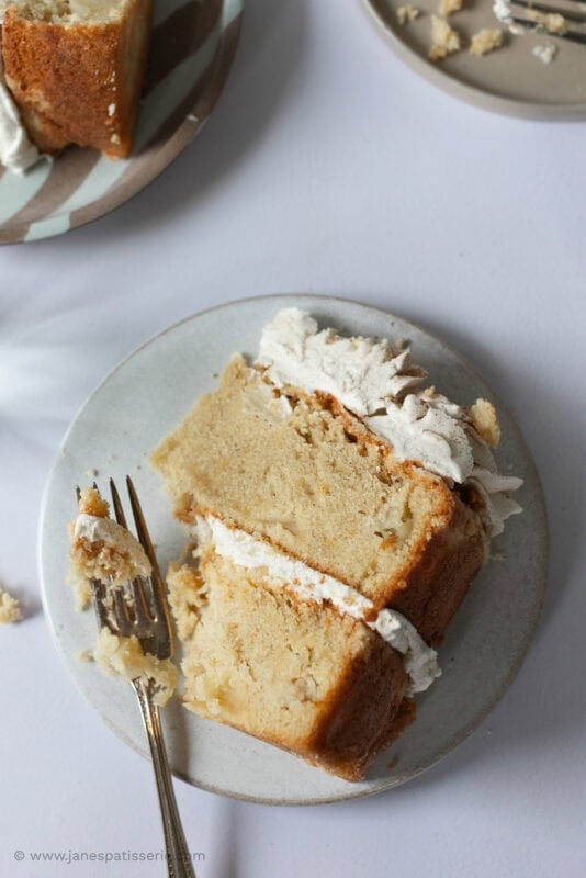 A fork cutting into a slice of apple crumble cake