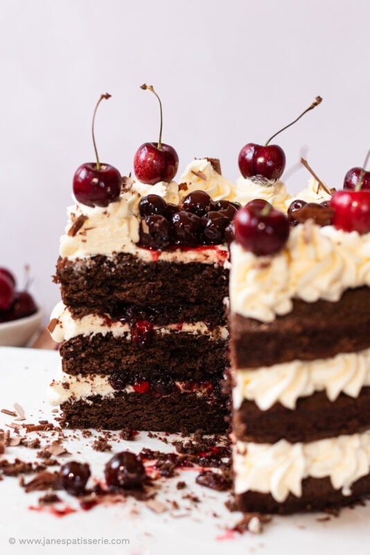 A slice missing from a black forest fudge cake