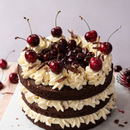 A top down shot of a black forest fudge cake with buttercream