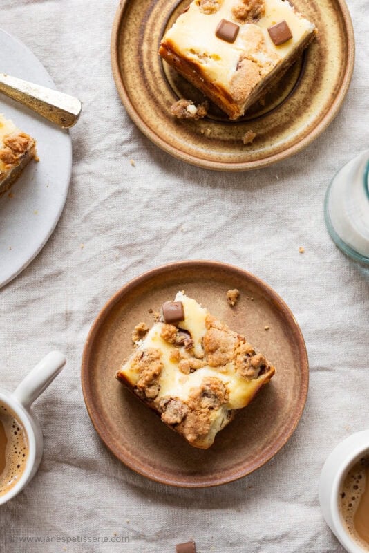 Cheesecake cookie bars on plates with Tea