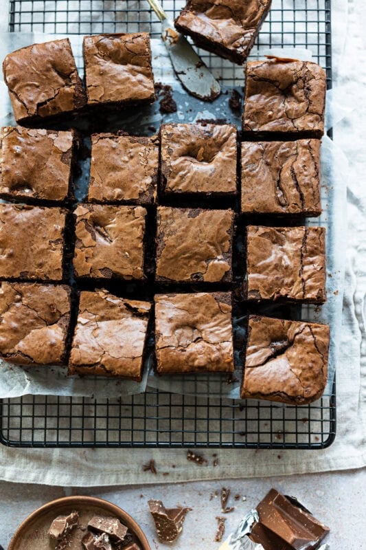 16 square slices of toblerone brownies on a cooling rack
