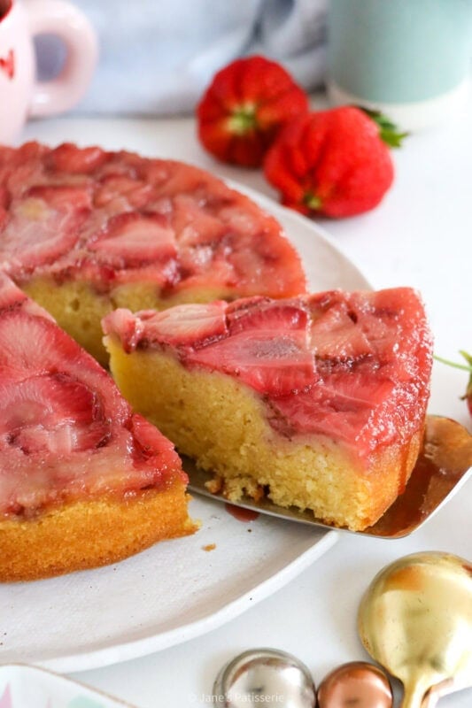 A slice of Strawberry Upside down Cake being served.