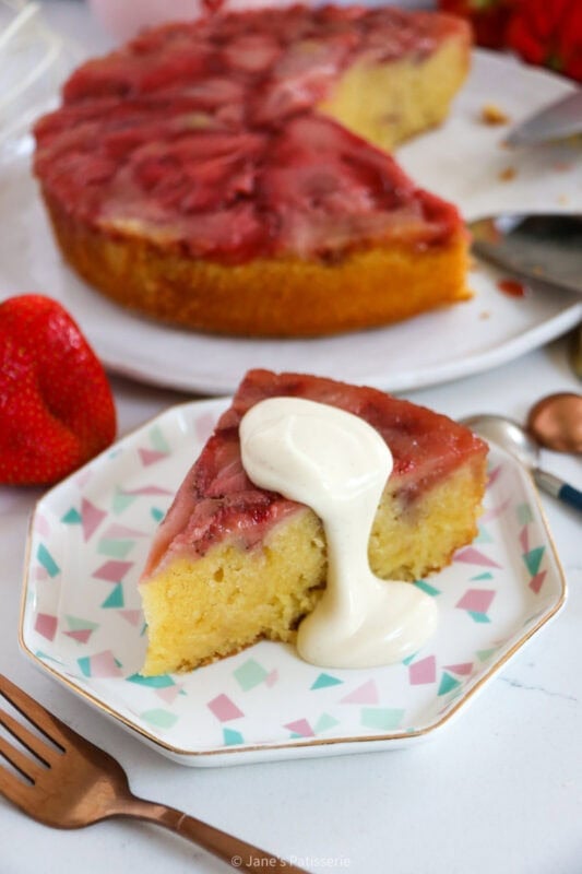 A serving of strawberry upside down cake with cream.