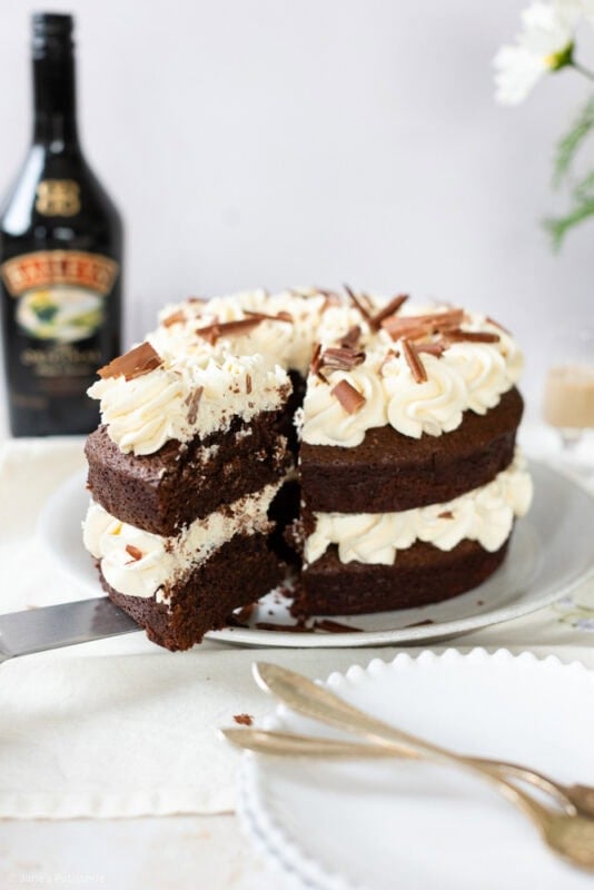 A slice being removed from a Baileys cake
