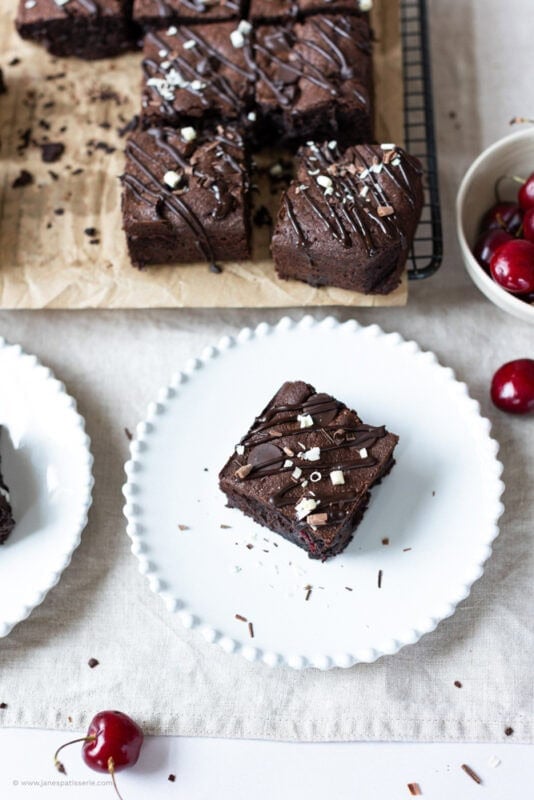 Black forest brownie on a plate with cherries