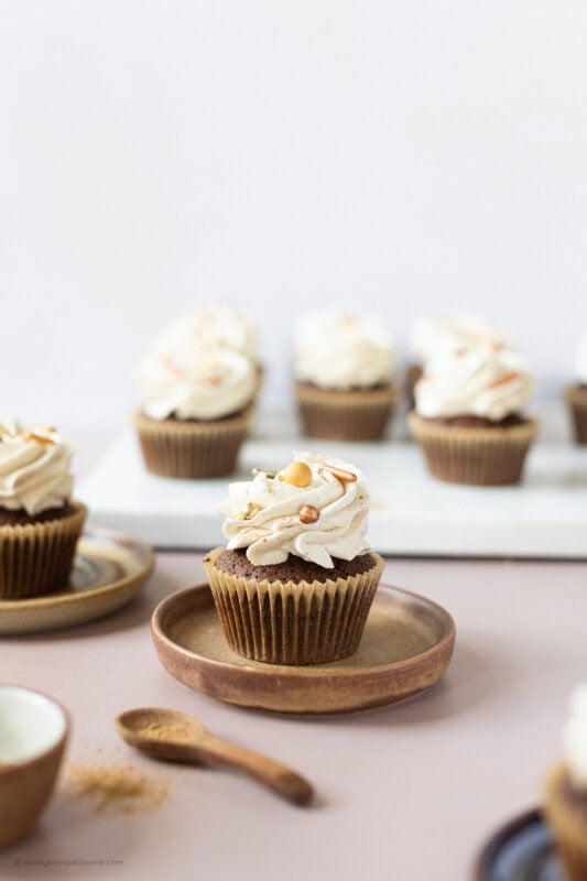 A side shot of a chocolate chai cupcake on a plate