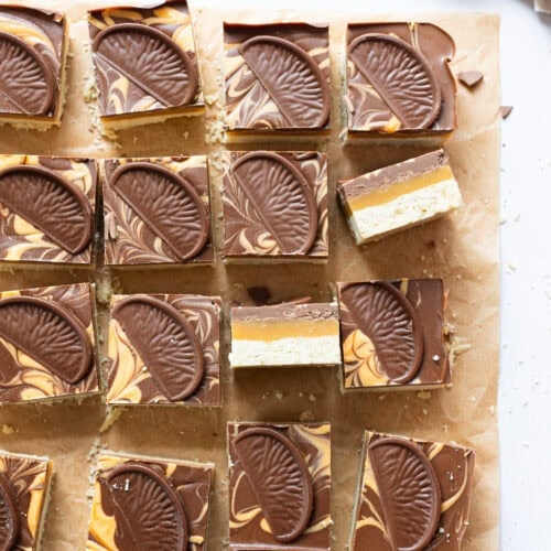 One turned on the side on a tray of Chocolate Orange Millionaires