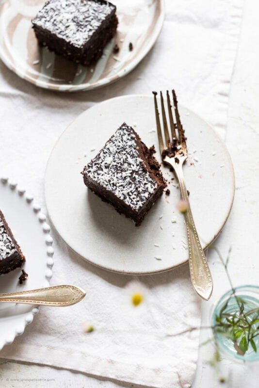 A wide shot of a coconut brownie on a plate