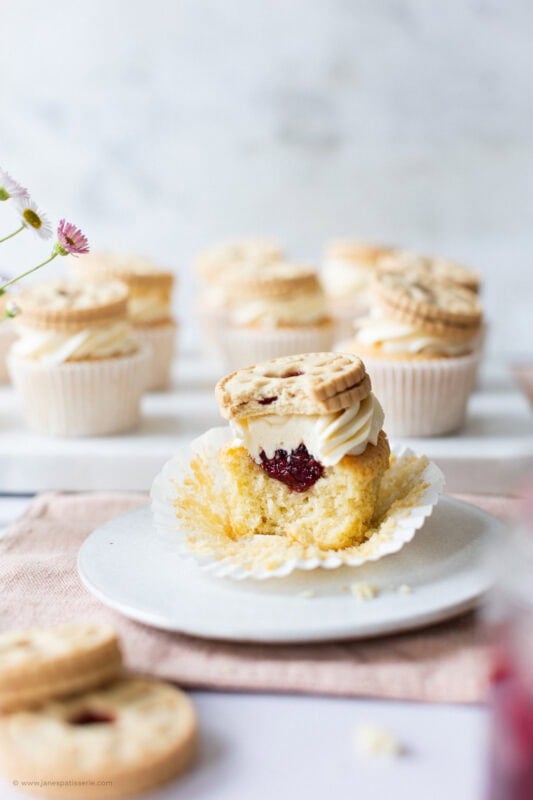 A longer shot of a half eaten Jammie Dodger Cupcake