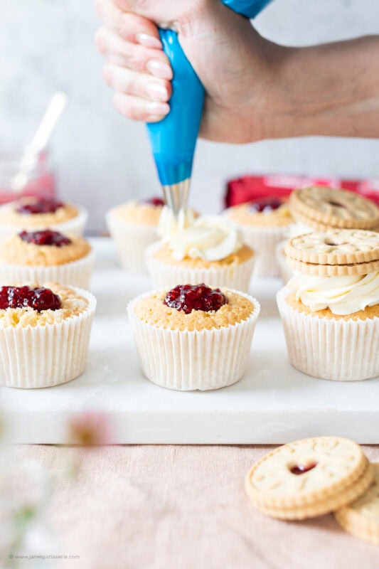 Piping onto a Jammie Dodger cupcake