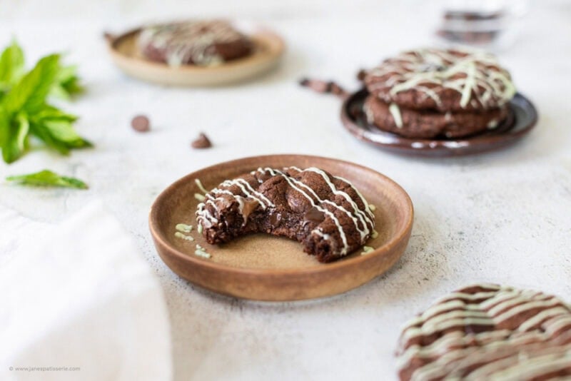 A bite missing from a mint chocolate cookie