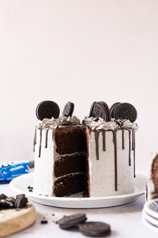 A slice missing of an Oreo Drip Cake