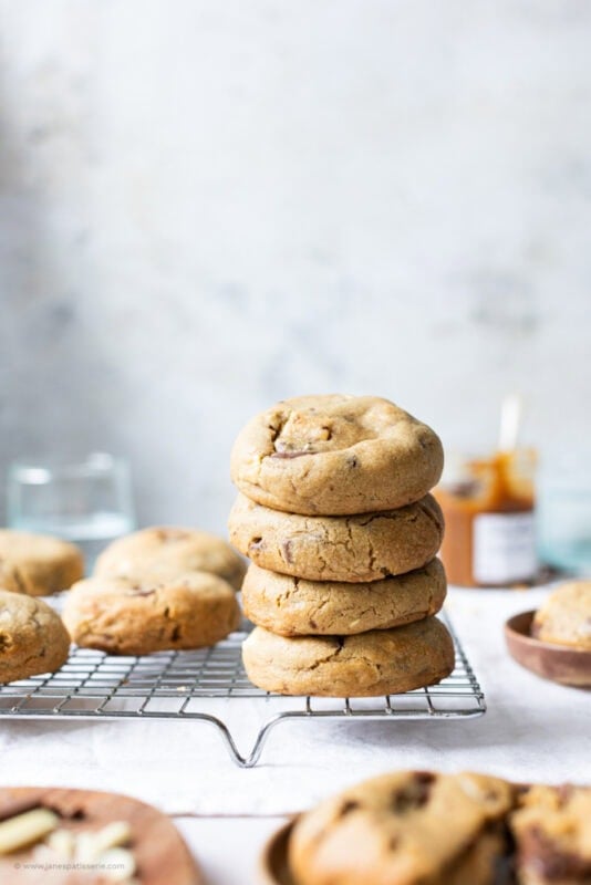 A stack of Salted Caramel Cheesecake Cookies on a baking tray