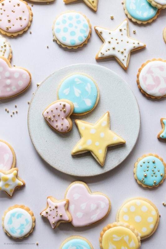 A plate of brightly decorated Sugar Cookies on a plate
