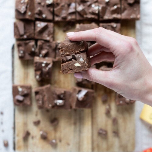 A hand holding up Toblerone Fudge above the tray