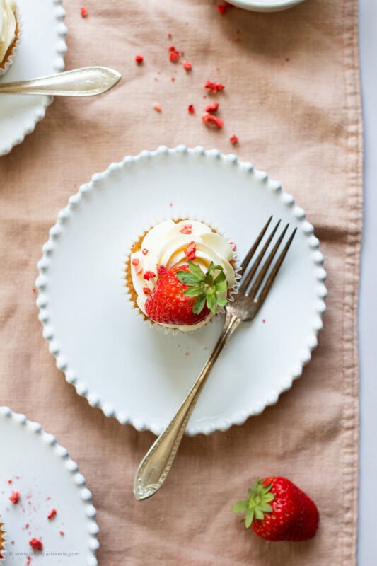 A Wimbledon Strawberry Cupcake on a white plate