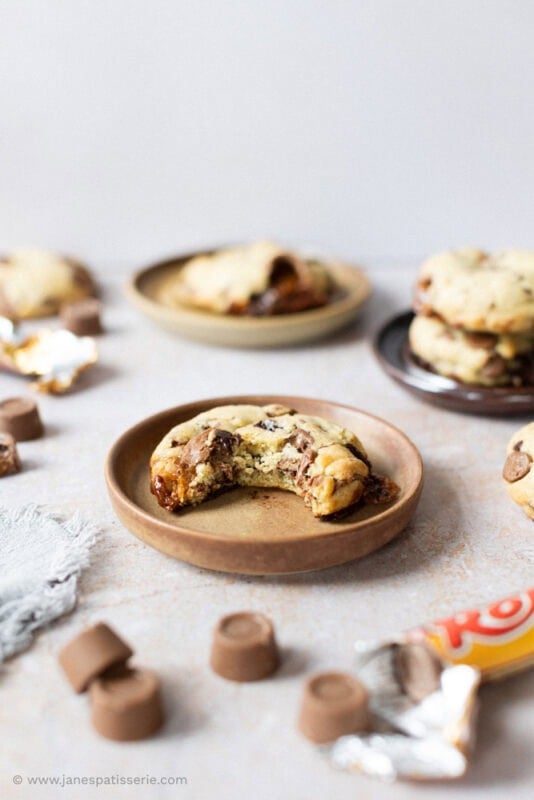 A bite missing from a Rolo Cookie on a plate