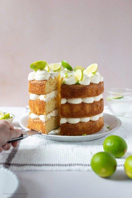 A slice being taken from a Gin and Tonic Cake