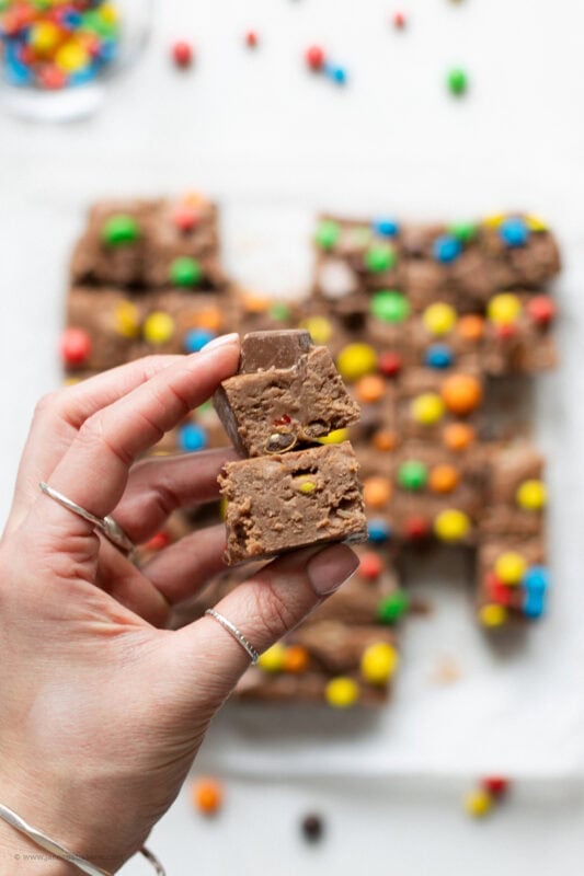 A hand holding two slices of microwave fudge