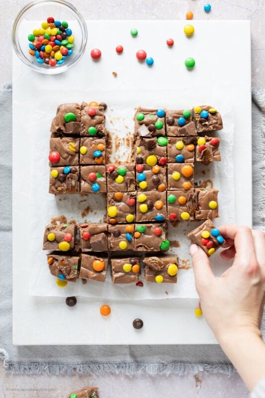 A hand taking a slice of microwave fudge