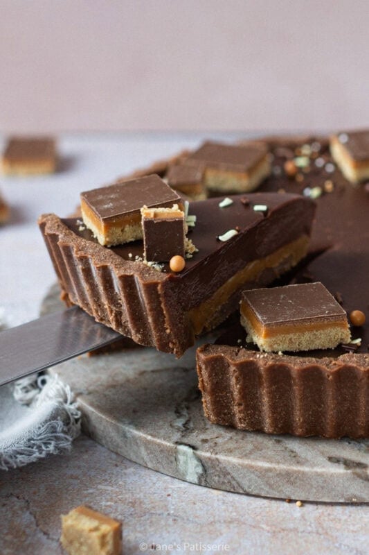 Decadent Billionaires Tart with a rich caramel center, topped with chocolate ganache and festive sprink.ii