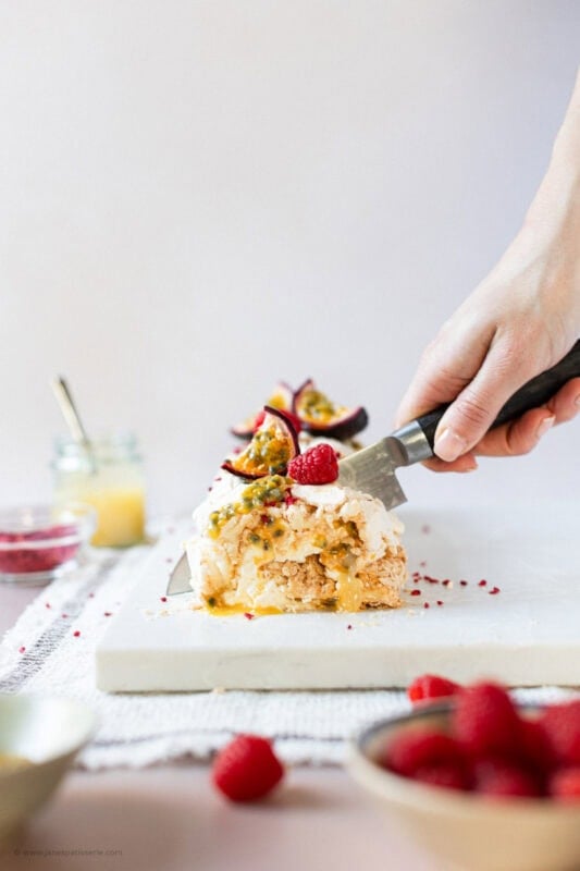 A knife cutting into the lemon meringue roulade