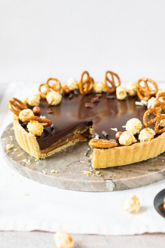 A slice missing from a Salted Caramel Tart