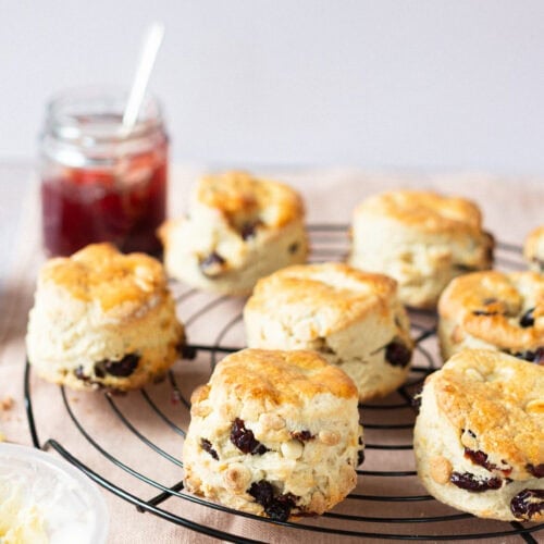 A batch of White Chocolate and Cranberry Scones on a cooling rack