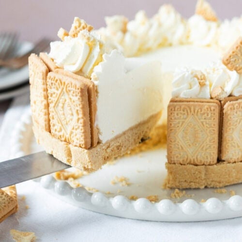 A slice being taken from a custard cream cheesecake