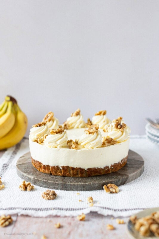 A side profile of a whole Banana Bread Cheesecake