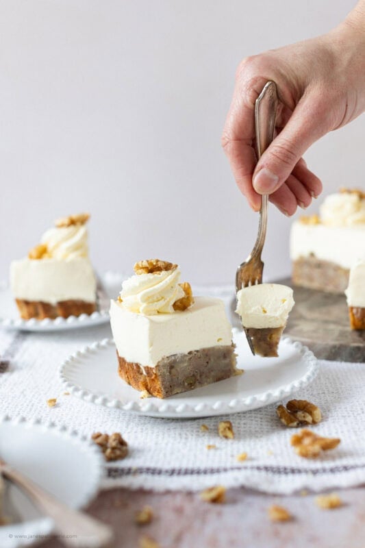 A fork cutting into a slice of Banana Bread Cheesecake