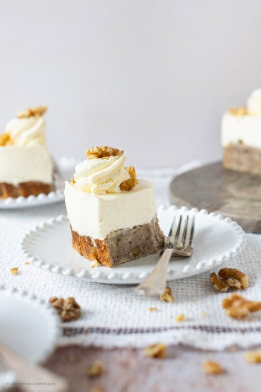 A half eaten slice of Banana Bread Cheesecake on a plate