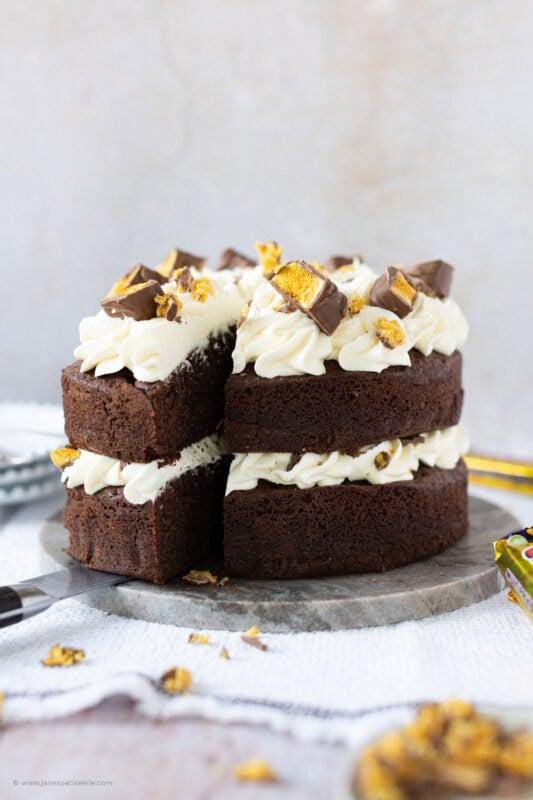 A slice into a Honeycomb Crunchie Cake