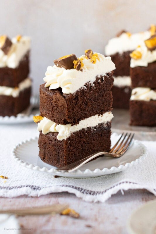 A slice of Honeycomb Crunchie Cake on a plate with a fork