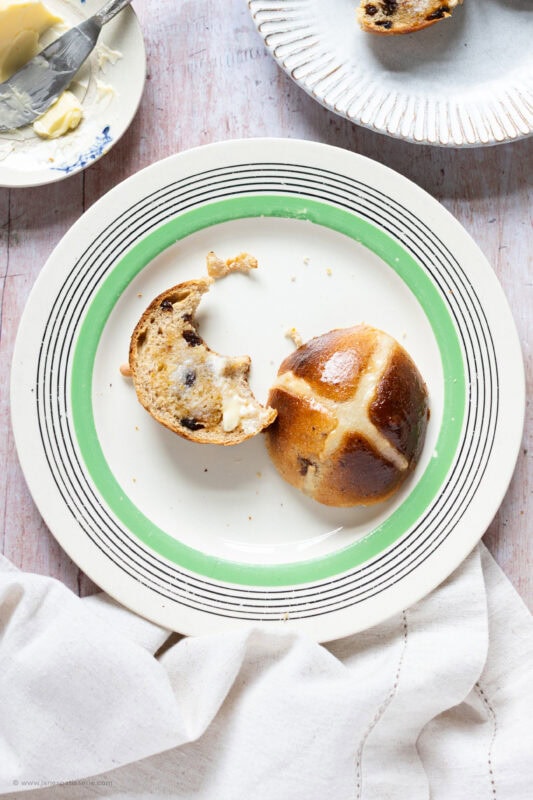 Close up of a hot cross bun on a plate