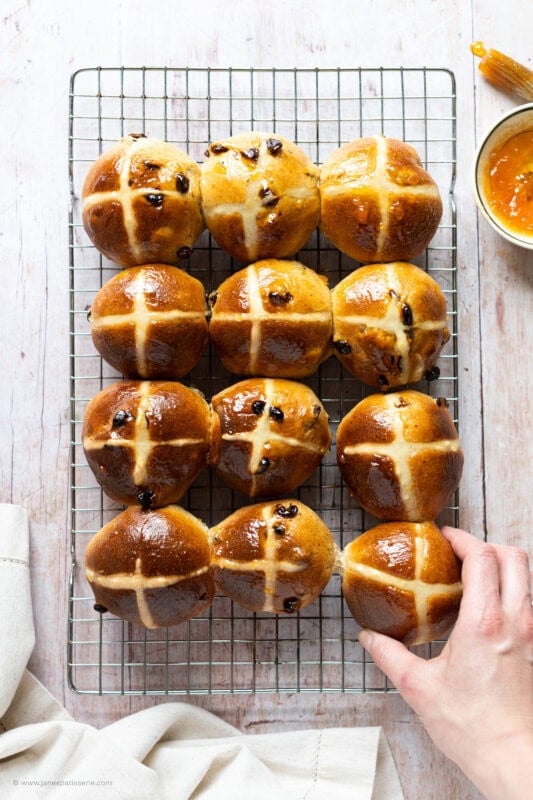 A cooling rack of hot cross buns