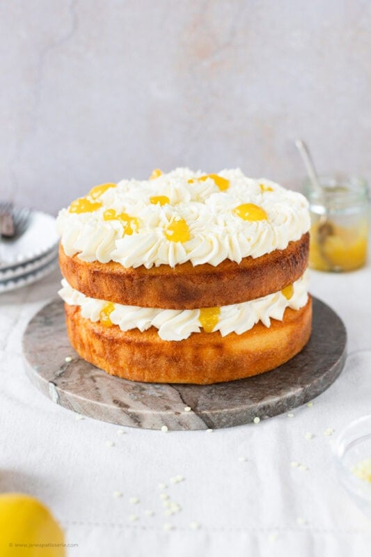 A whole Lemon Celebration Cake on a serving block
