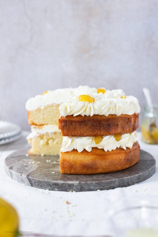 A slice taken from a whole Lemon Celebration Cake