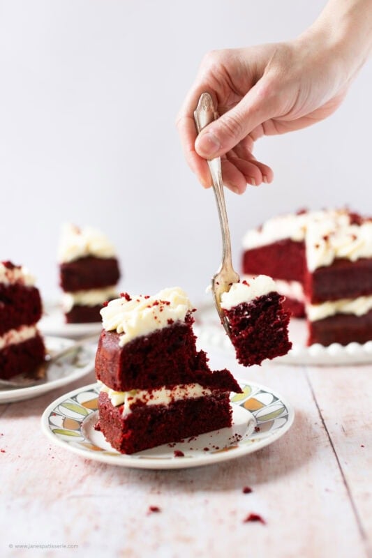 A fork cutting into a slice of Red velvet cake