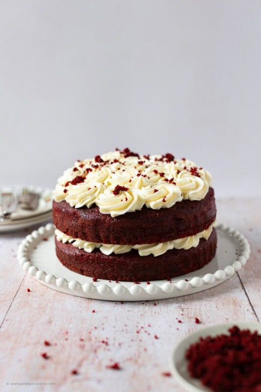 A whole Red velvet cake on a serving dish